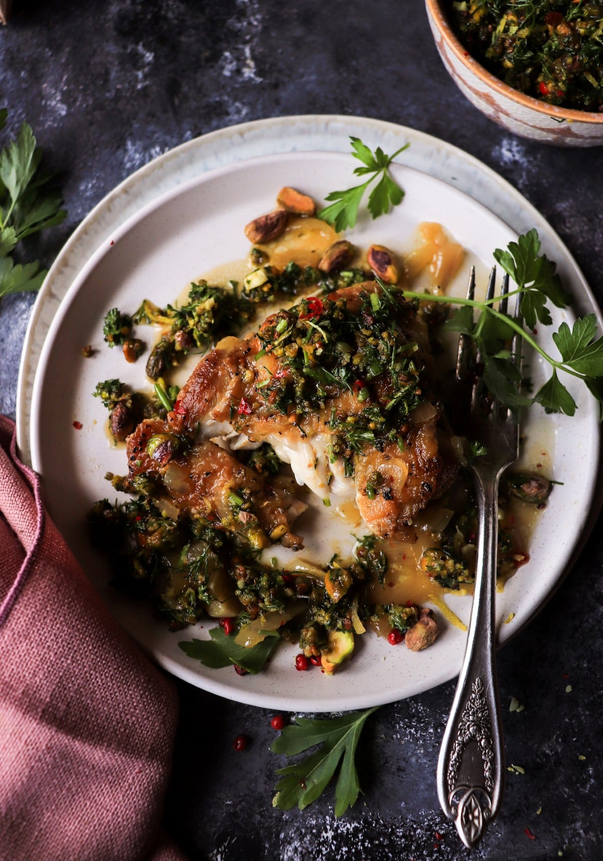 Cut chicken thigh with silky white wine sauce and pistachio herb topping