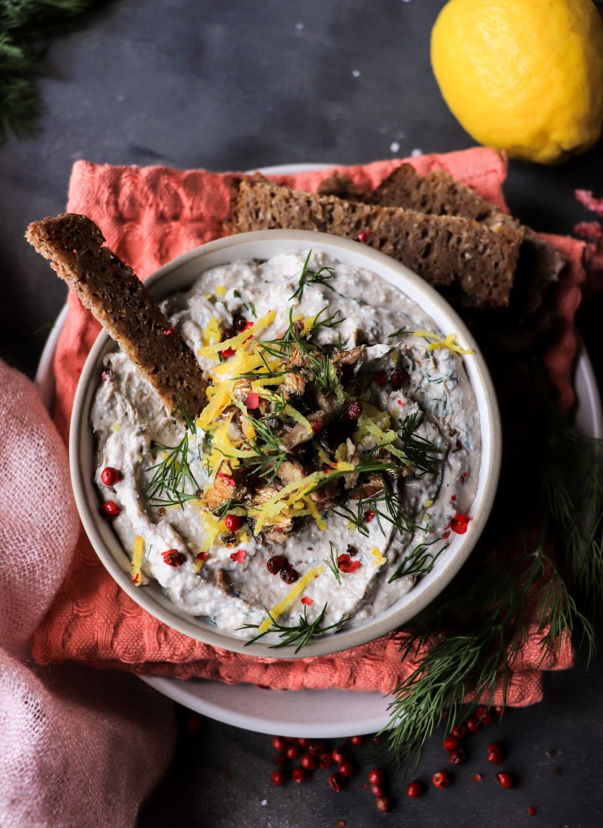 Smoked sprats spread with pressed cottage cheese and rye bread