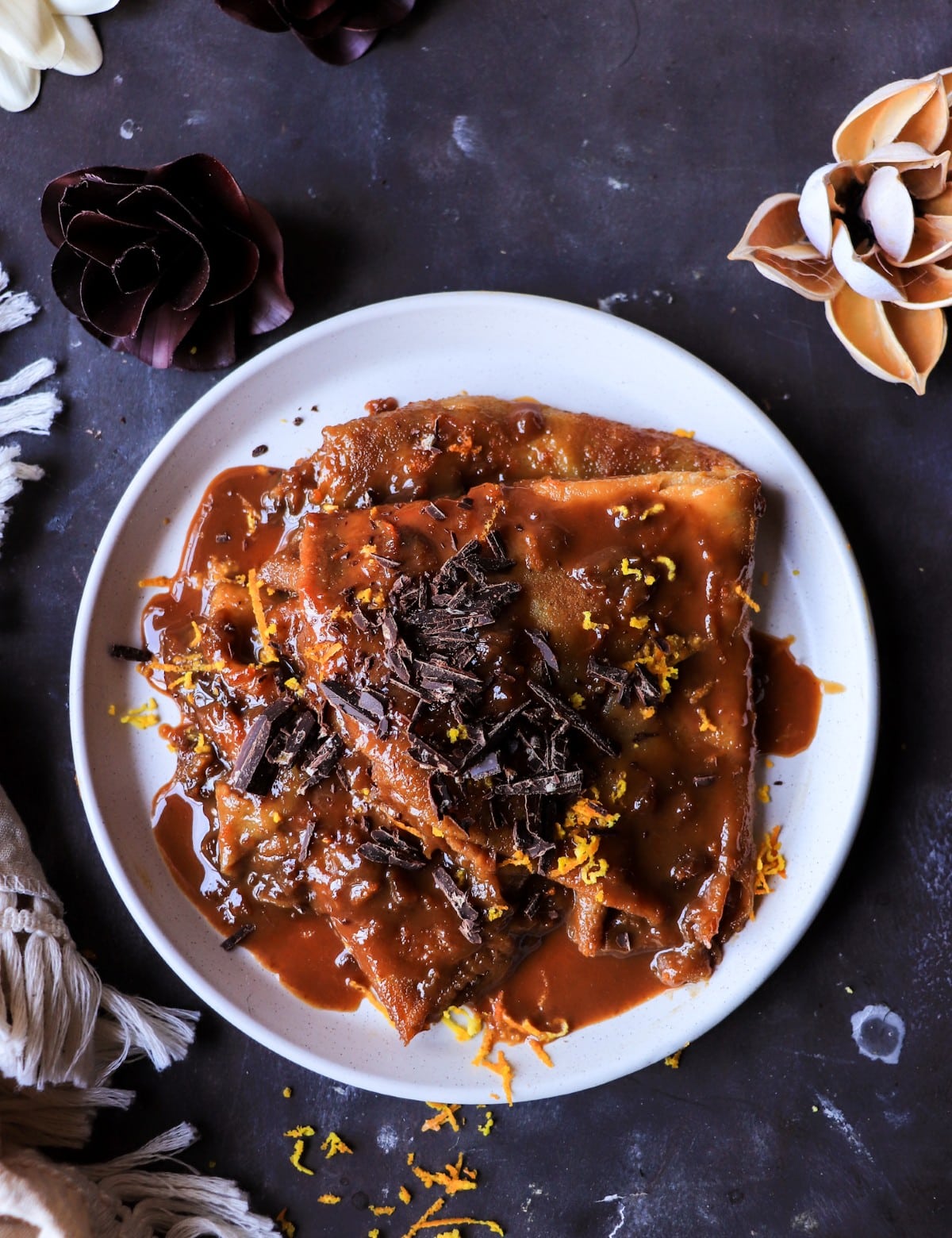 Caramelized dulce de leche crepes topped with dark chocolate and orange zest.