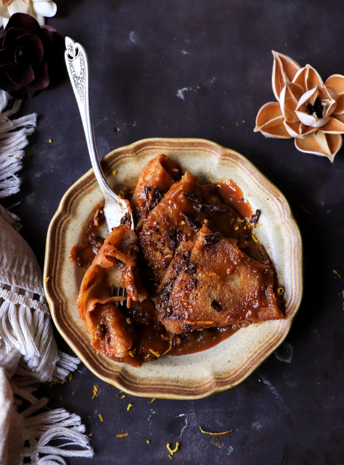 Boozy caramelized Crêpes with dark rum dulce sauce and chocolate shavings