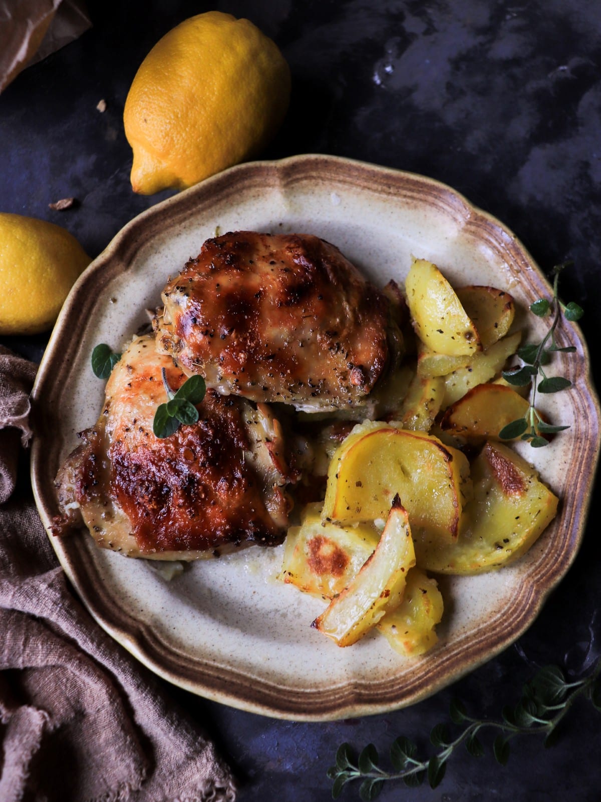 Greek lemon oregano chicken with roasted potatoes, golden chicken thighs with crispy skin and tender potatoes