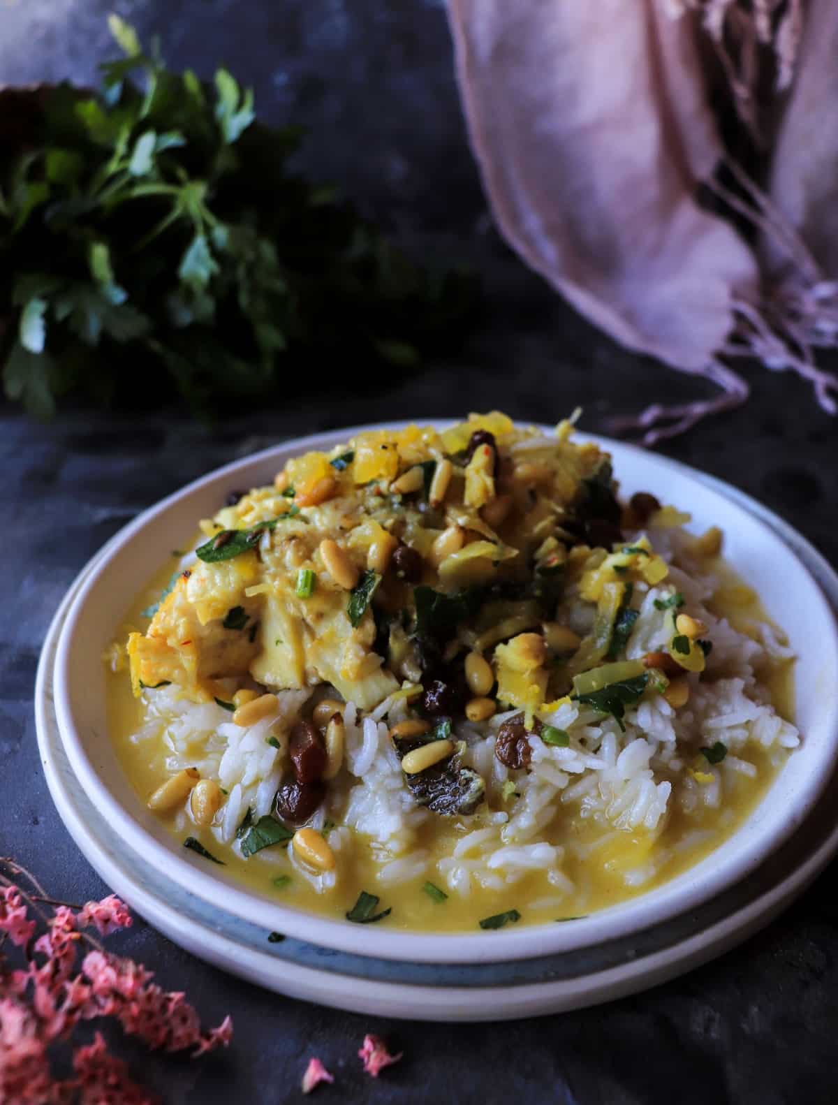 Halibut with saffron, raisins, and pine nuts served over rice
