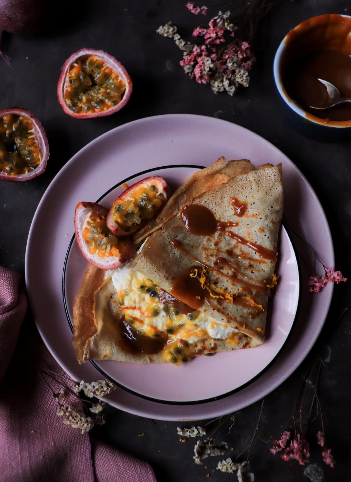 Dulce de leche crêpes with passion fruit and orange zest.