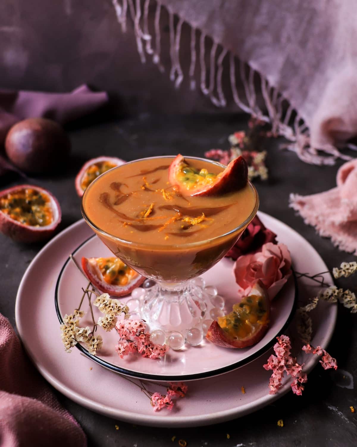 Passion Fruit Dulce de Leche Rum Cocktail with Crème de Passion, dark rum, orange zest, and fresh passion fruit.