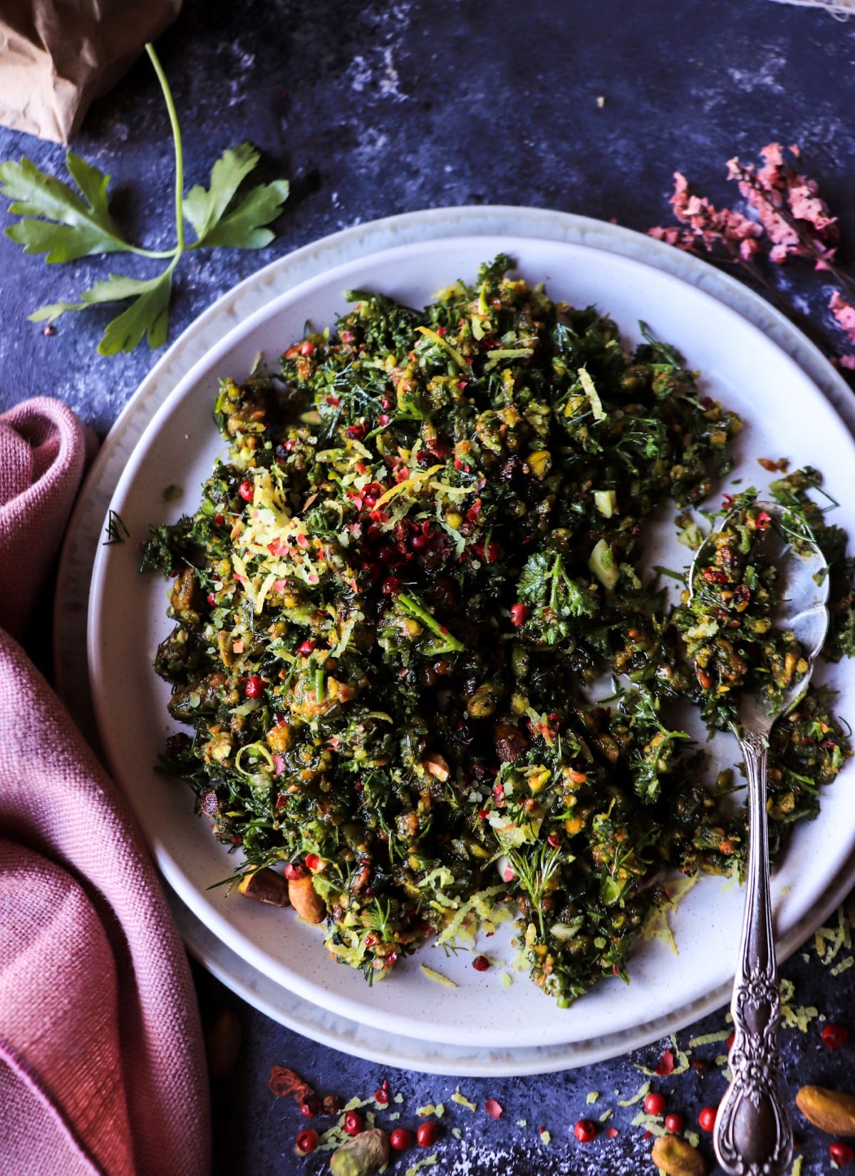 Pistachio gremolata spread on a plate with lemon zest and herbs