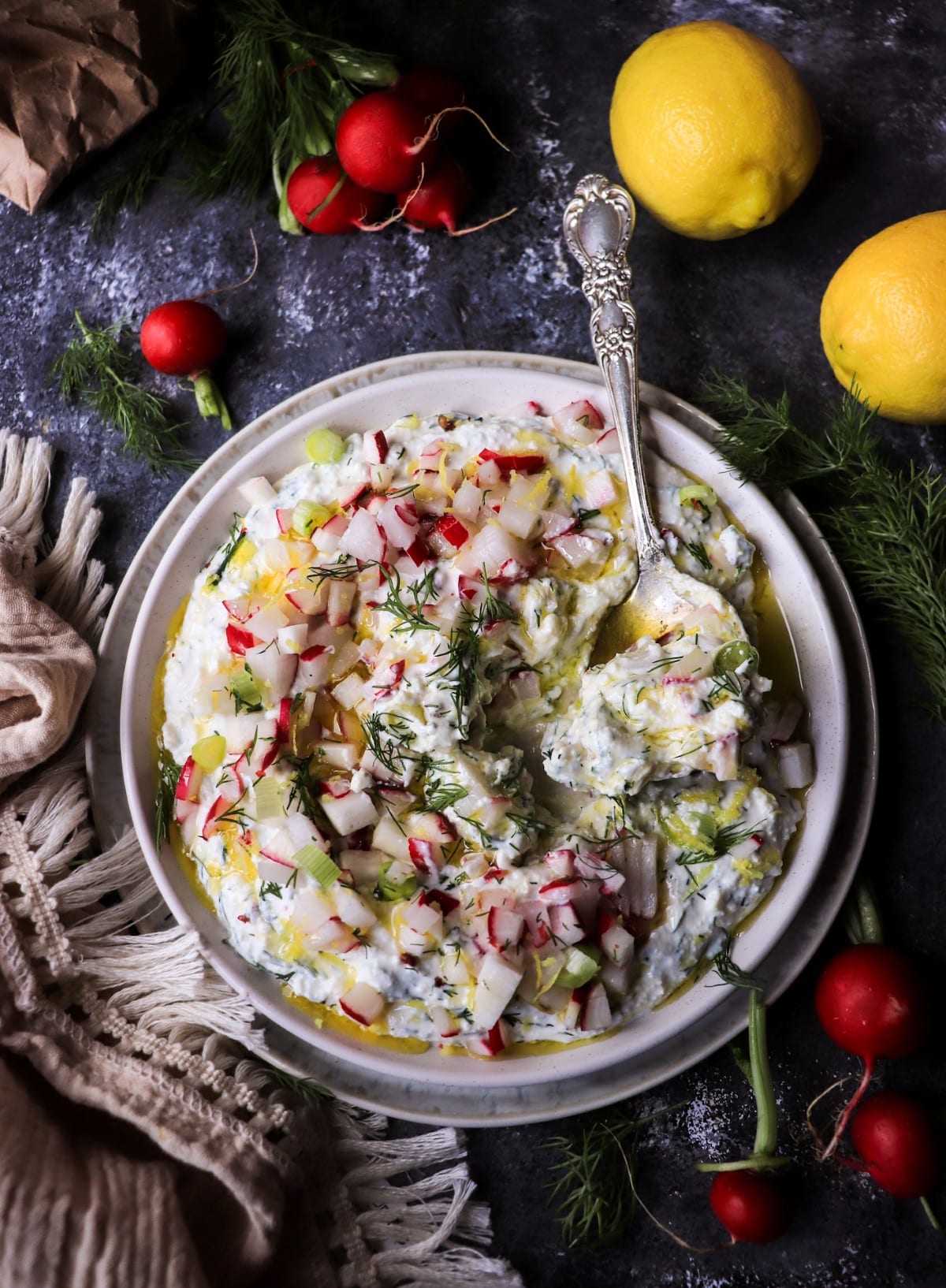 Creamy feta spread with radishes, dill, lemon, and olive oil. A fresh rustic spring appetizer perfect with rye bread or crackers.