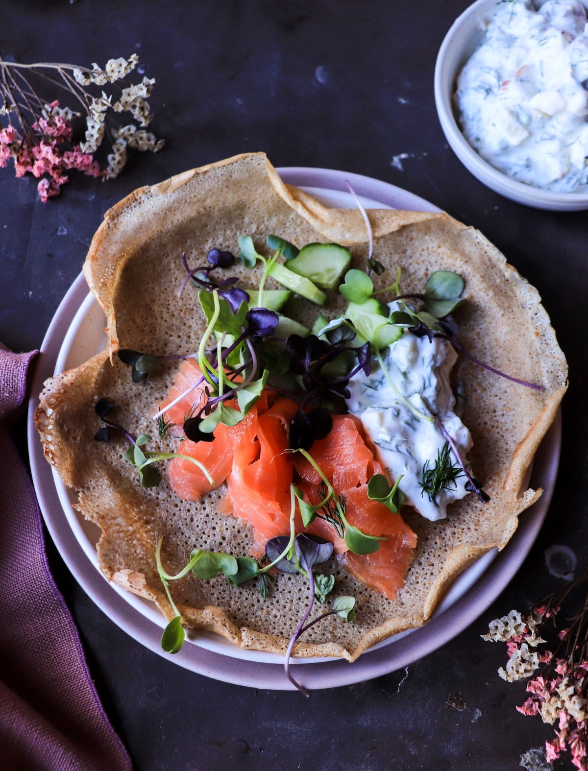 Rye crêpes with smoked salmon, cucumber, sprouts, and horseradish apple sauce.