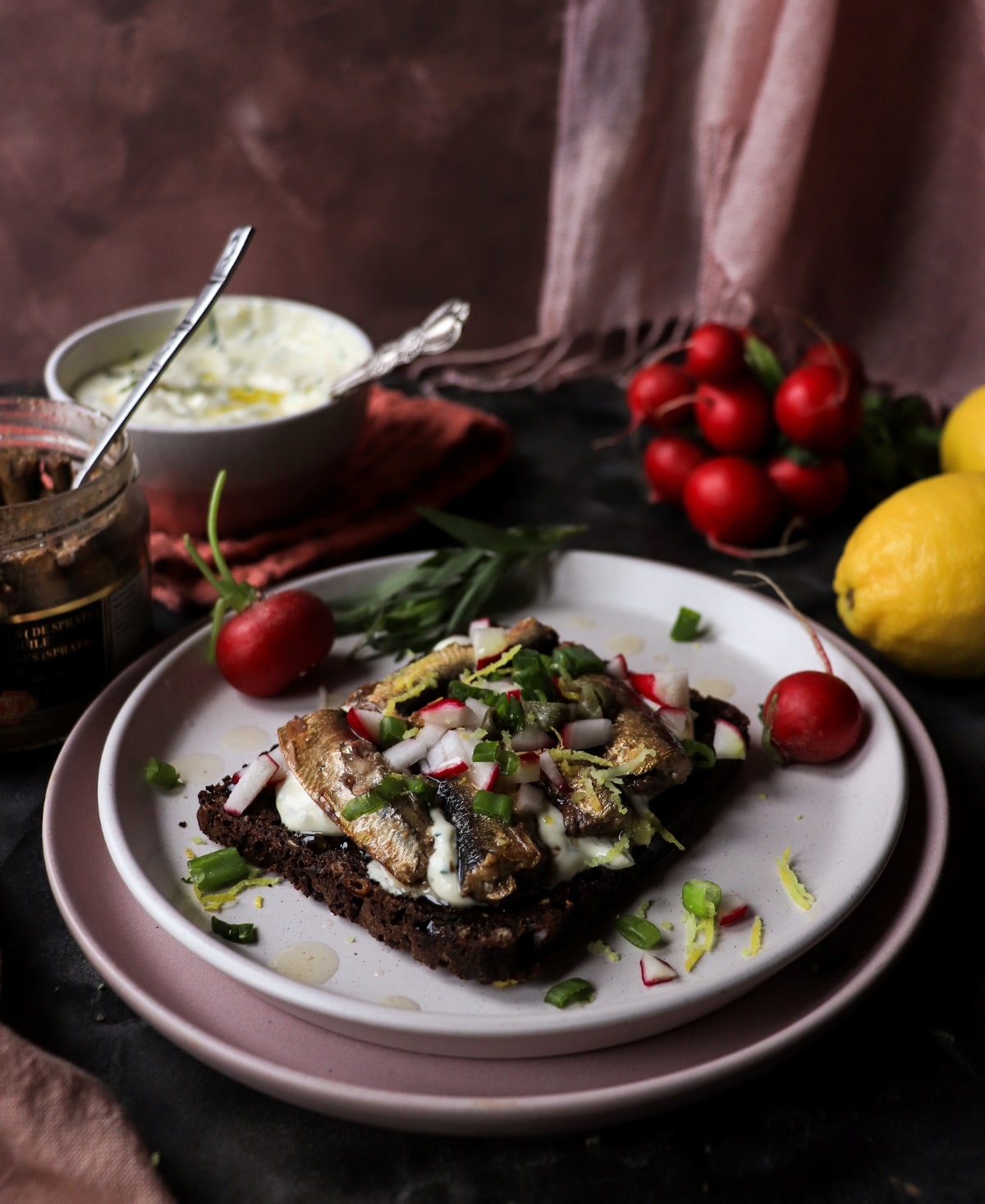 rye toast with sprats and tarragon sauce on dark rye bread