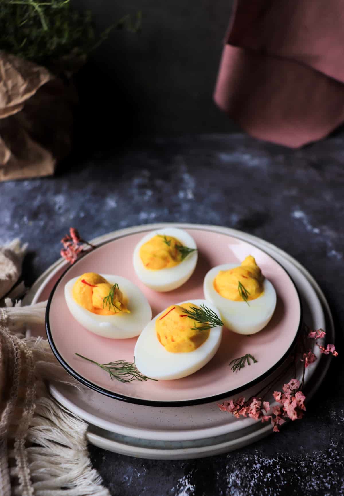 saffron deviled eggs with dill garnish