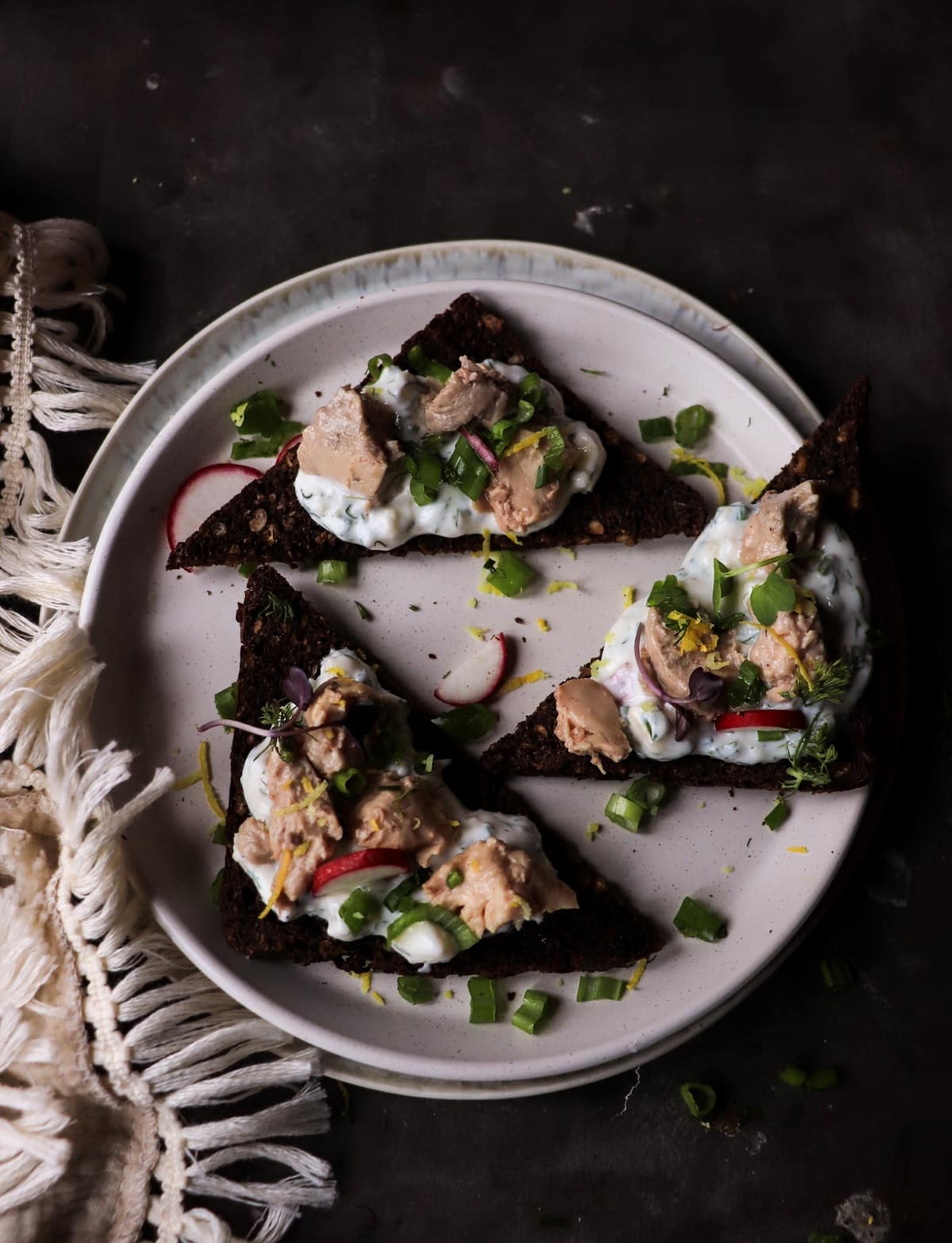 Smoked cod liver rye toast with lemon zest, radishes, and green onions