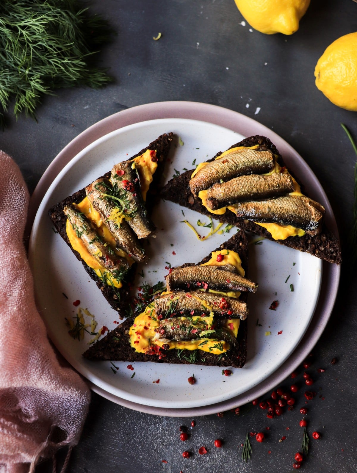 Smoked sprats on rye with saffron yolk mousse