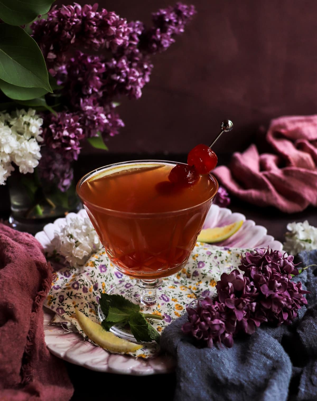 Cherry Orange Gin Sour served in a coupe glass with cherry garnish and lemon