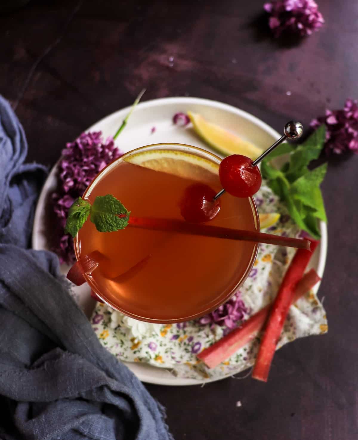 Cherry Rhubarb Gin Sour with homemade rhubarb syrup and cherry garnish