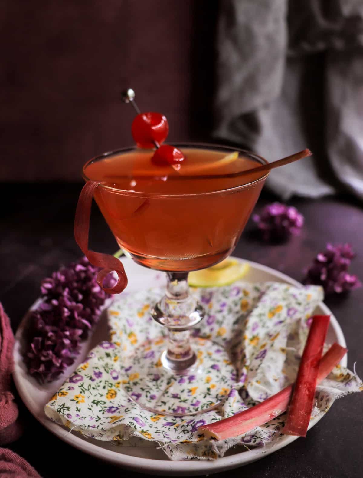 Elegant Cherry Rhubarb Gin Sour cocktail made with homemade rhubarb syrup and Empress gin