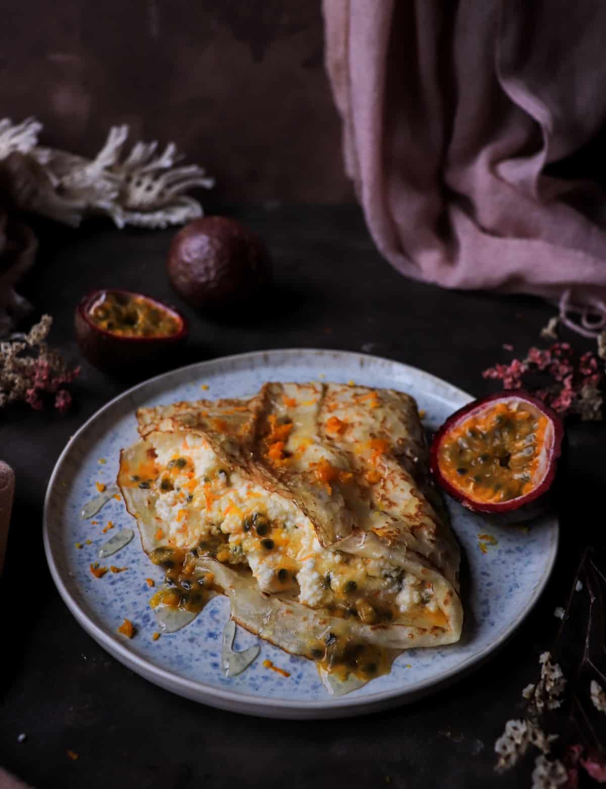 Orange Ricotta Crêpes with Passion Fruit and honey drizzle