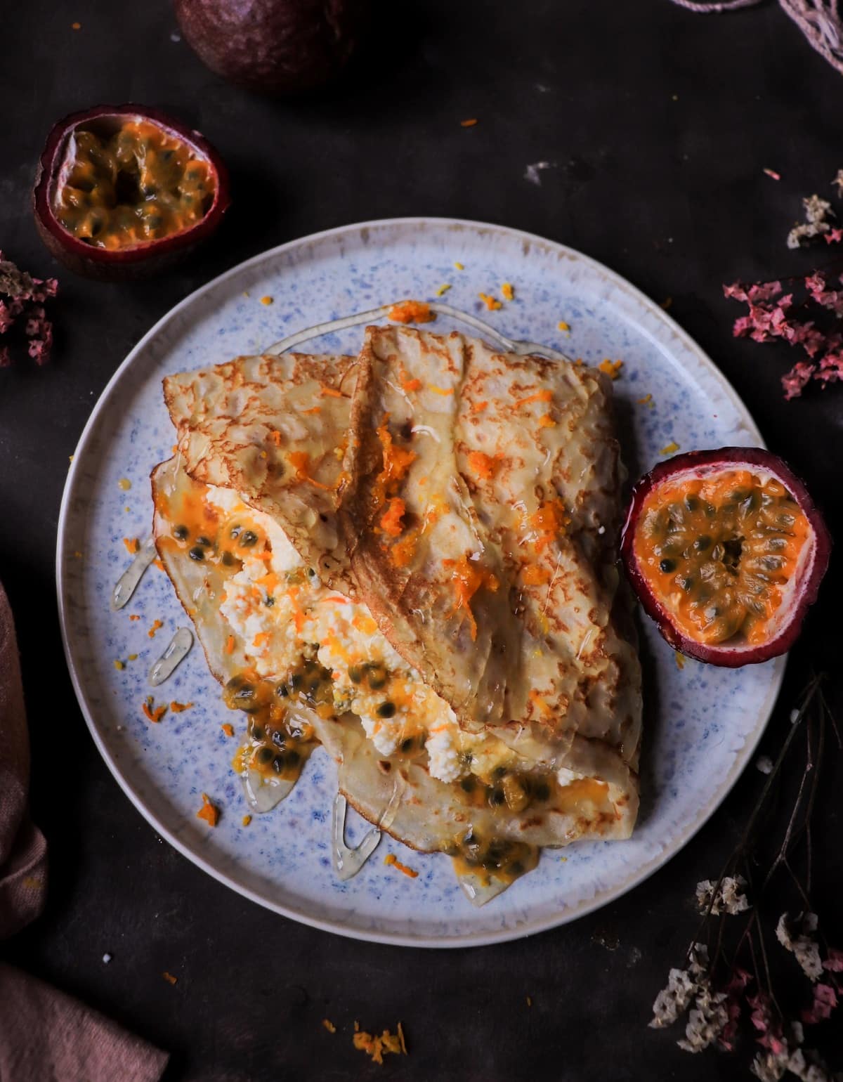 Orange Ricotta Crêpes with Passion Fruit served with honey and orange zest
