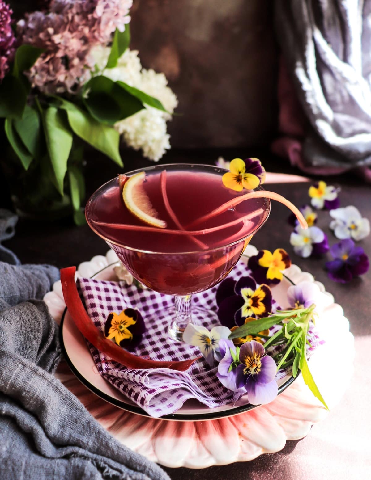 Rhubarb gin cocktail decorated with edible flowers