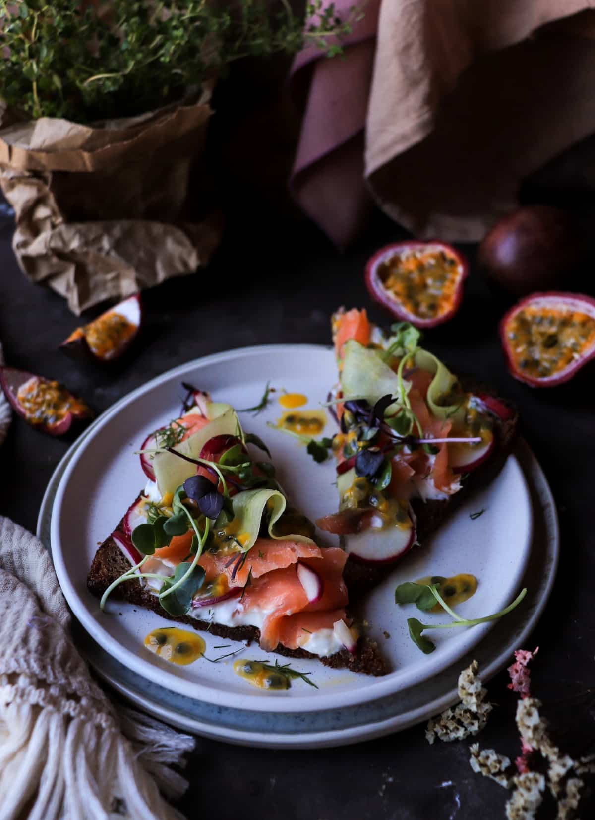 Nordic-inspired smoked salmon appetizer on rye bread with passion fruit