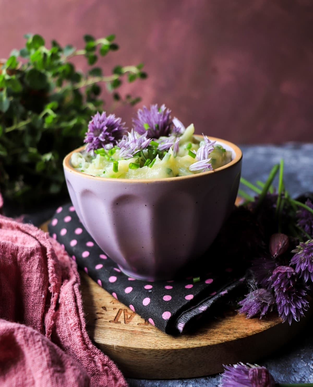 Homemade chive honey compound butter with edible chive blossoms