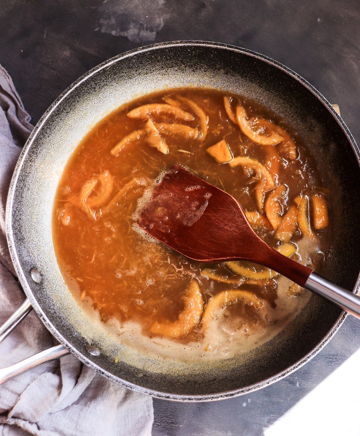 Honey-lemon preserves simmering for Crêpes Suzette with lemon and violet liqueur