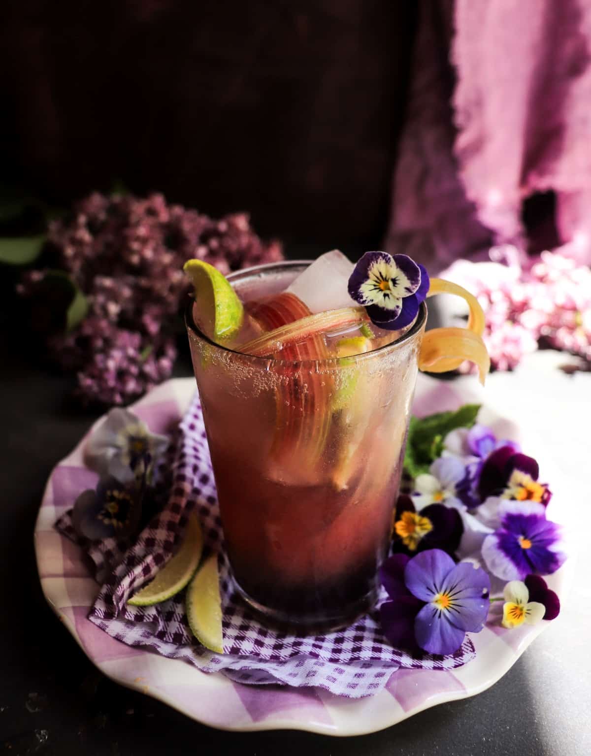 Floral gin fizz cocktail with rhubarb syrup and crème de violette
