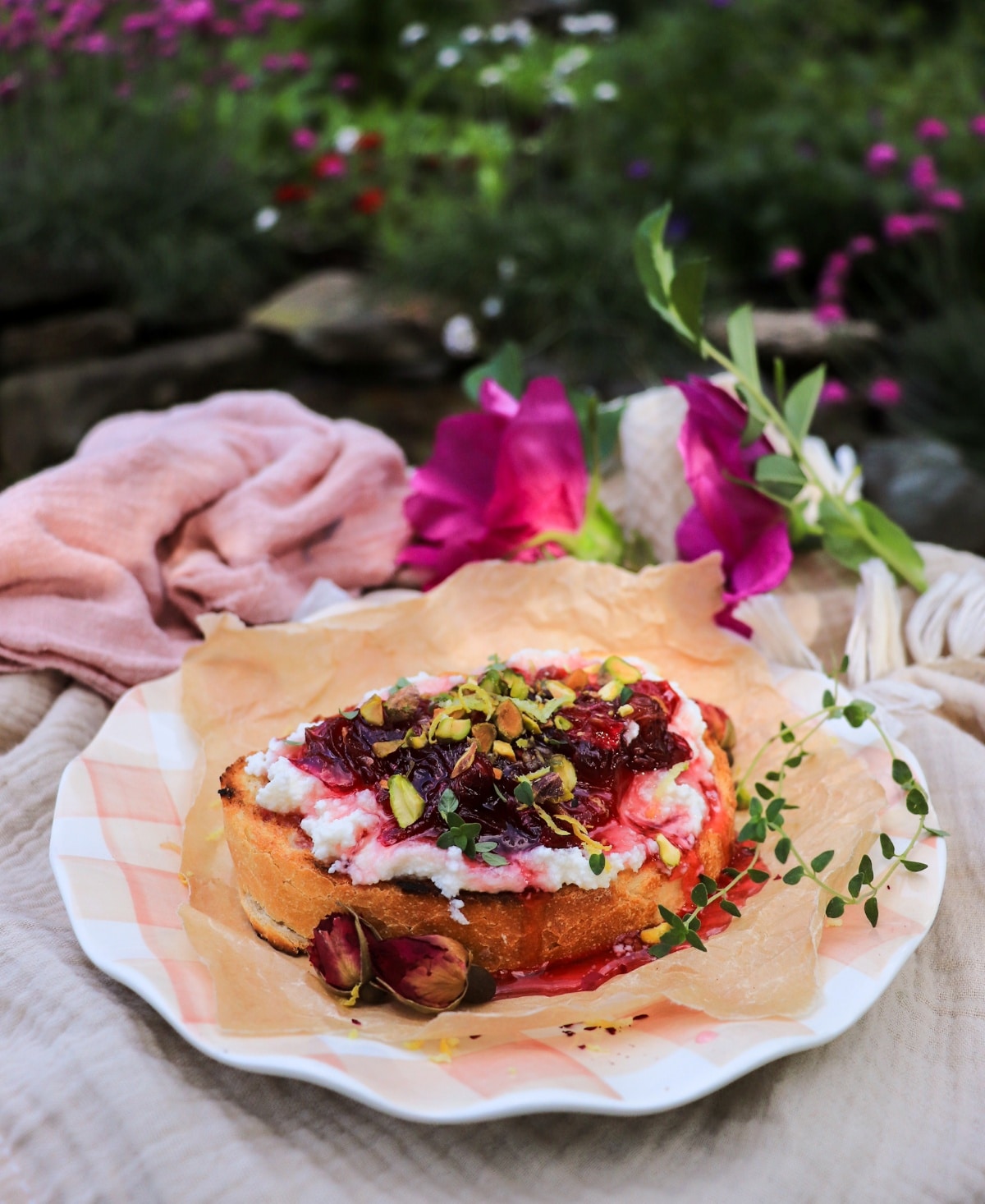 Gourmet ricotta toast with rose jam, pistachios, lemon zest and thyme