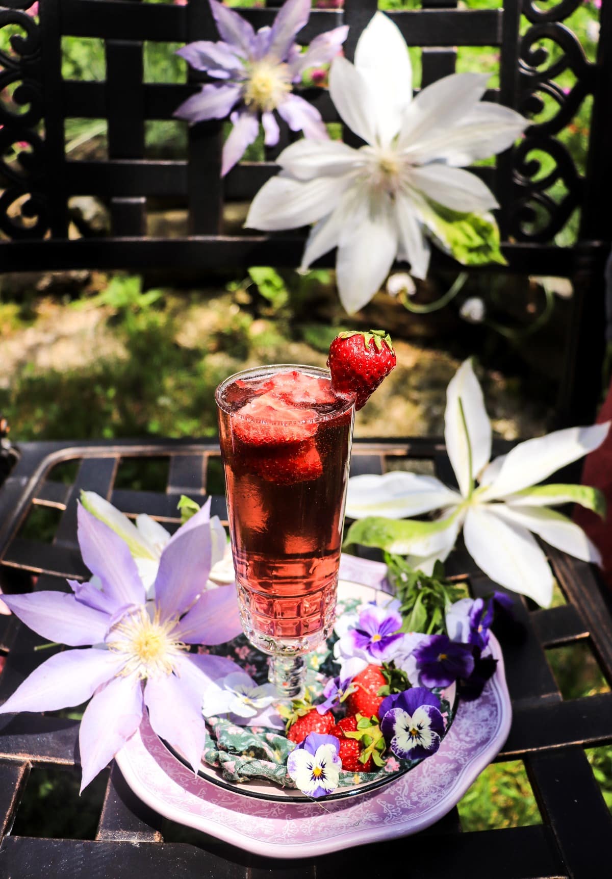 Strawberry French 75 with crème de violette served with fresh strawberries