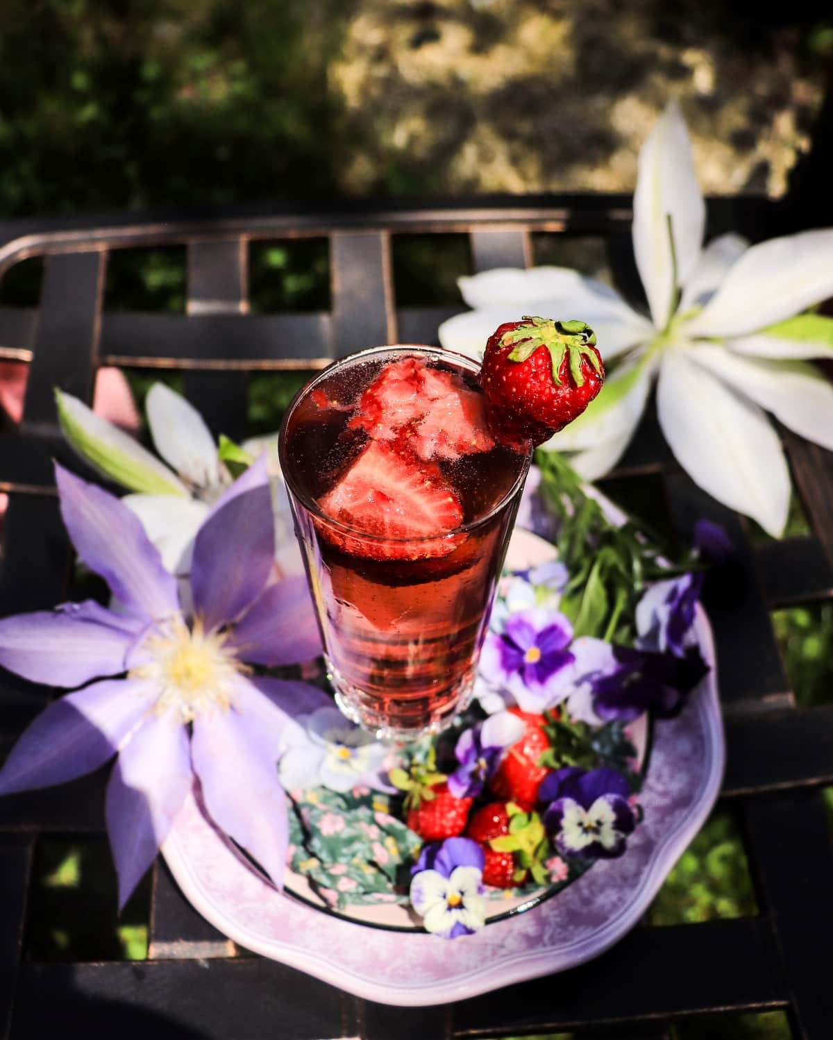 Strawberry French 75 with violet liqueur and muddled fresh strawberries