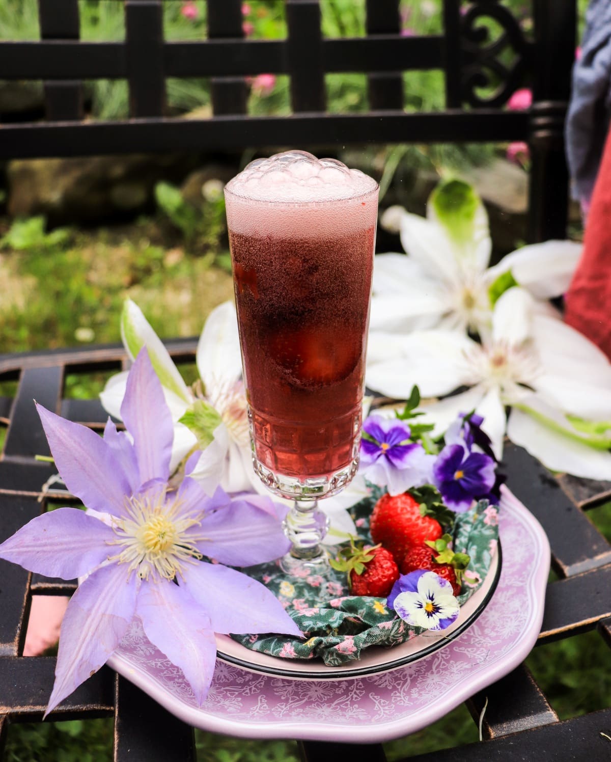 Sparkling strawberry French 75 cocktail with gin and violet liqueur