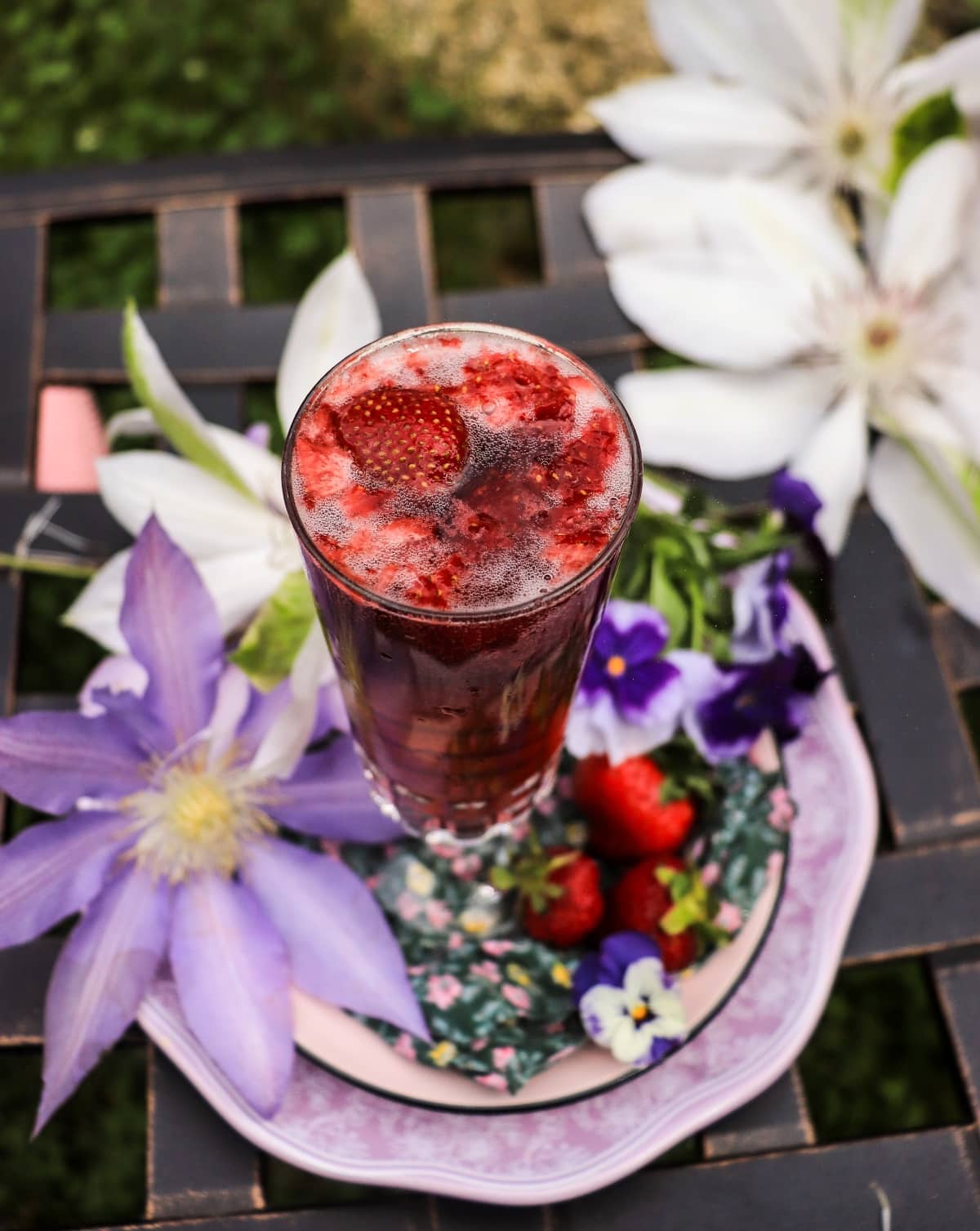 Violet French 75 with strawberries, gin, lemon, and sparkling wine