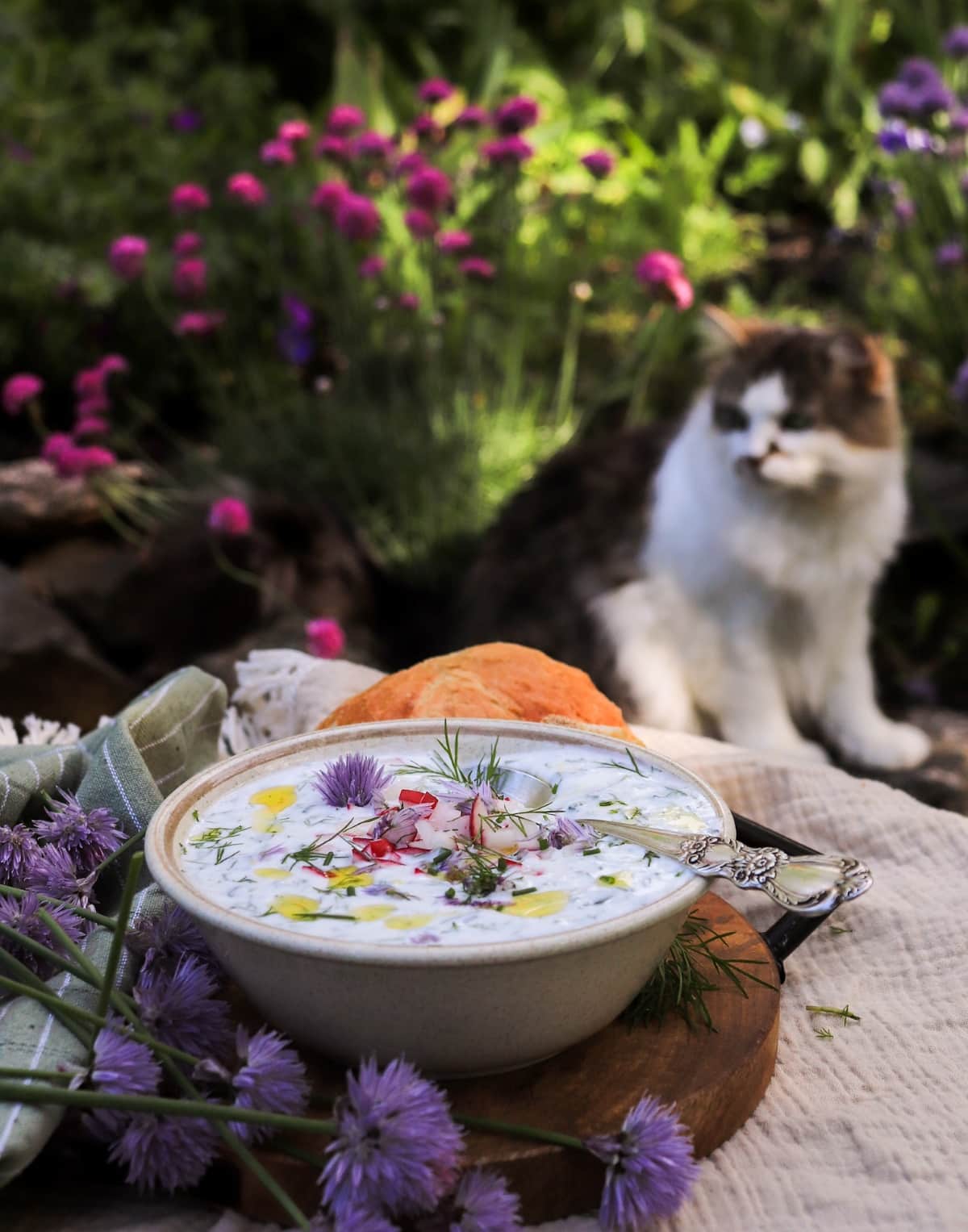 Cold cucumber soup with kefir and yogurt, dill, radishes, and chive blossoms