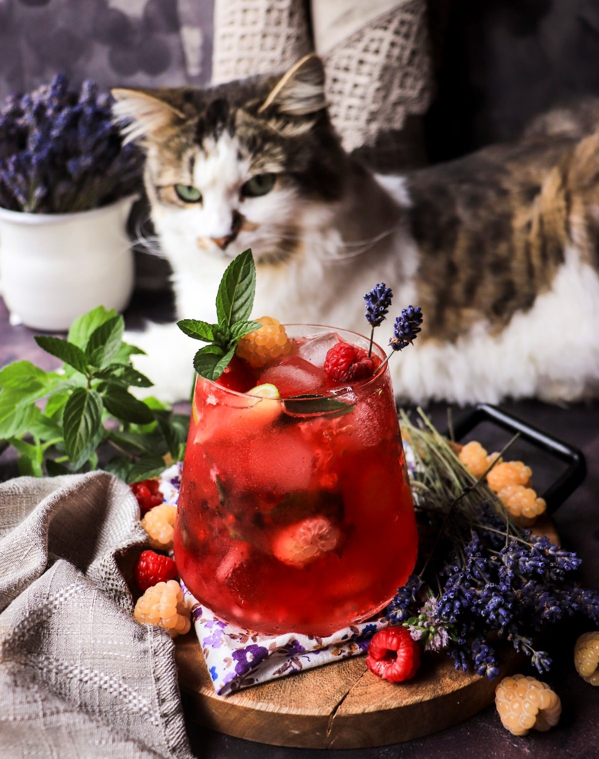 Raspberry lavender mocktail with lime, mint, mixed garden raspberries, and lavender