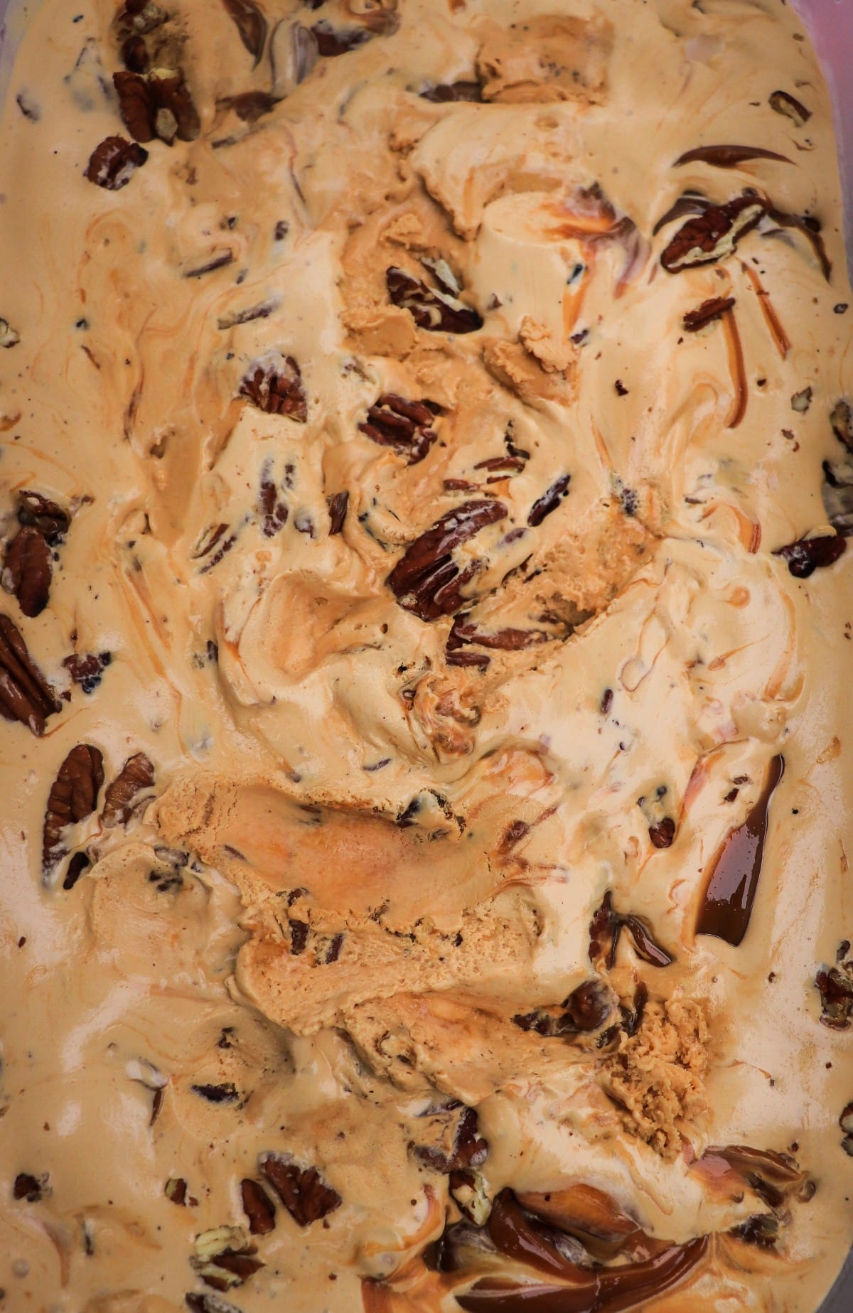 Homemade dulce de leche ice cream with pecans and dulce de leche swirls