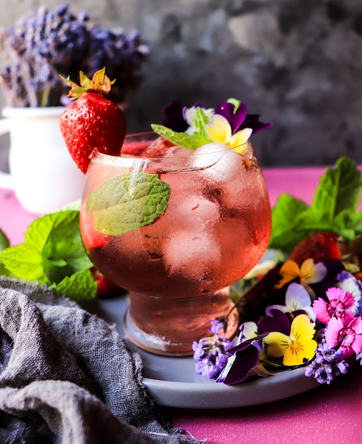 Violet sangria with crème de violette, rosé, strawberries, and fresh mint