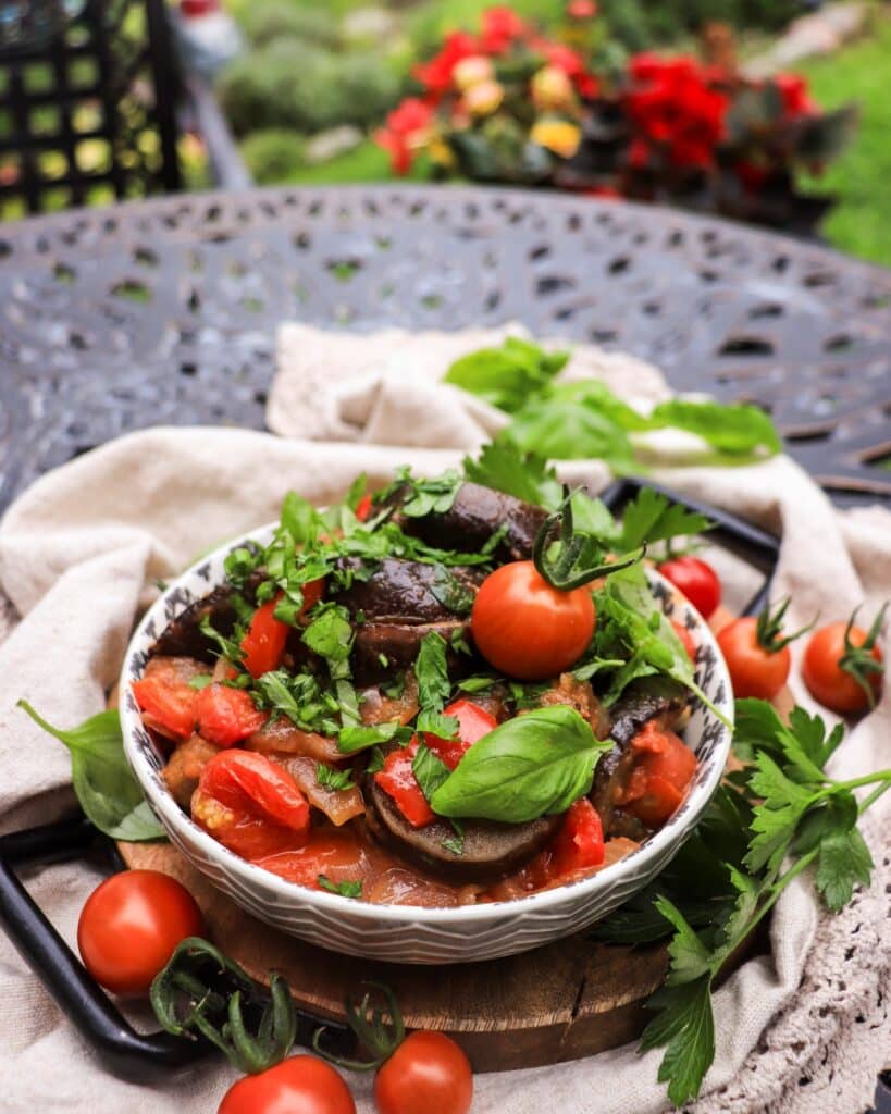 eggplant pepper tomato stew topped with fresh cilantro and basil