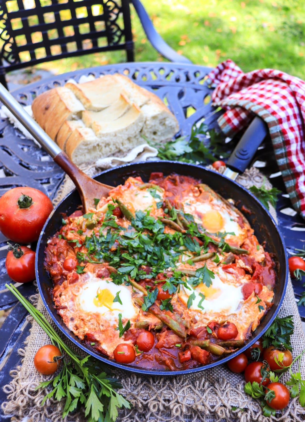 green bean shakshuka with fresh tomatoes and poached eggs