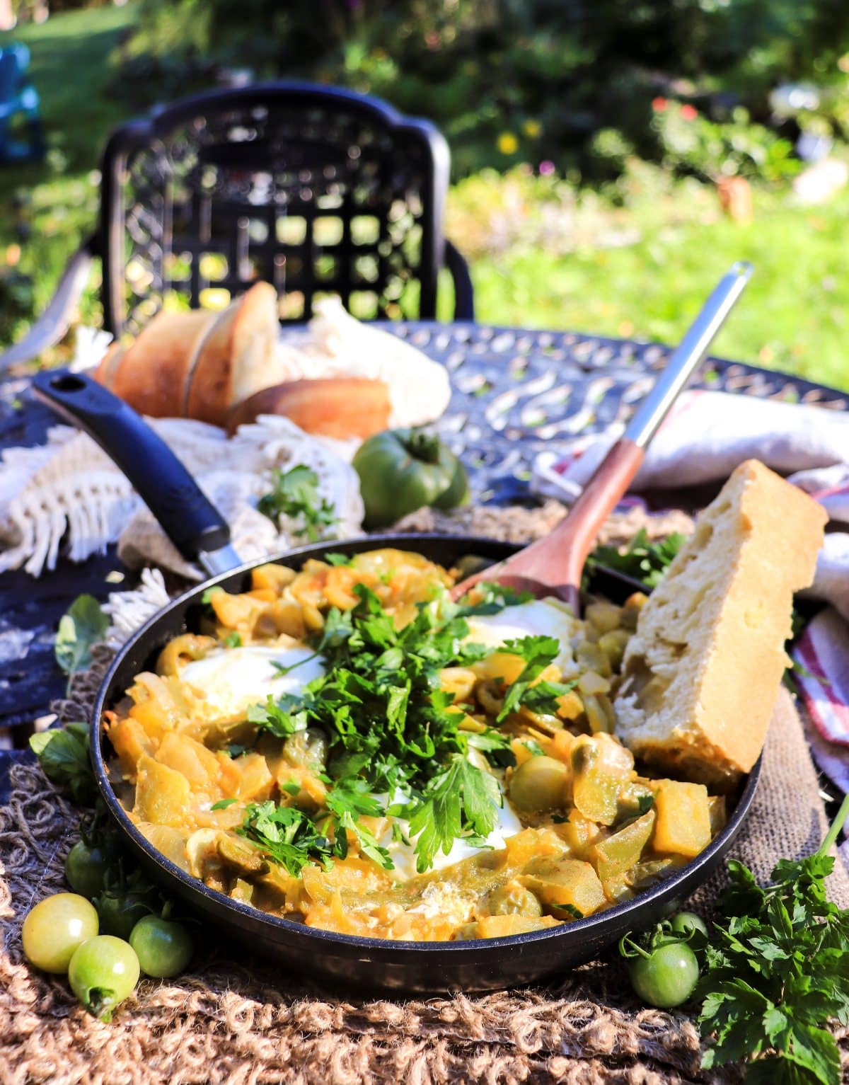 rustic green shakshuka garnished with fresh cilantro and parsley